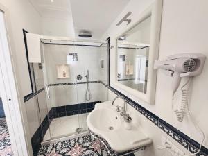 La salle de bains est pourvue d'une douche et d'un lavabo. dans l'établissement A Gradillo holiday rooms, à Ravello