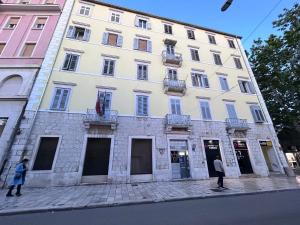 a large white building on the side of a street at K&K2 Luxury Studios in Split