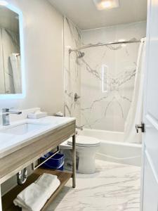 a bathroom with a sink and a toilet and a shower at Nob Hill Motor Inn -Newly Updated Rooms! in San Francisco