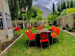 een tafel en stoelen in de tuin van een huis bij Al Jannat Hotel & Relax Inn Guest House Skardu in Skardu
