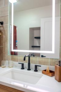 a bathroom sink with a large mirror above it at The Beer Dome in Willcox