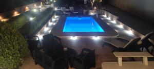 an overhead view of a swimming pool at night at Mastic House in Chios