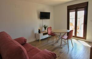 a living room with a couch and a table and chairs at Apartamentos La Vera de Gredos in Villanueva de la Vera