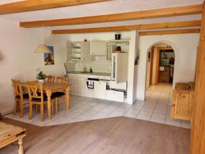 a kitchen and dining room with a table and chairs at Hotel Madrisajoch in Sankt Antönien