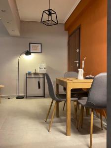 a dining room with a wooden table and chairs at Miliannas in Athens