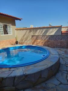 - une grande piscine dans une cour avec une maison dans l'établissement Casa Temporada Espaço Sara Piscina Aquecimento Solar, à São Lourenço