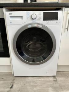 a white washing machine sitting in a kitchen at Central Colwyn Bay Studio Flat 2A in Colwyn Bay