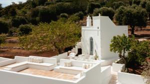 an aerial view of a white house with white couches at Torretta Le Feritoie - piscina e terrazza vista mare in Fasano +74 photos