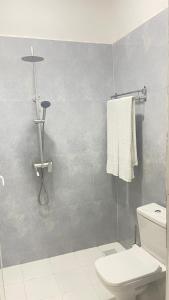 uma casa de banho com WC e uma toalha na parede em PM Lodge and Restaurant em Matemwe