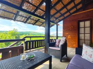 a porch with a table and chairs and a view at Villa Ruhige Lage in Rakovica