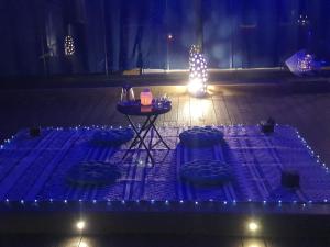 a table with chairs and a lit up christmas tree at Spa Ibiza Dosrius in Canyamás