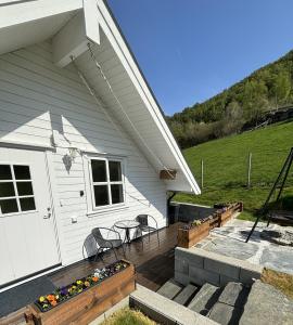 a porch of a house with a table and chairs at Fjord road in Hjelmeland