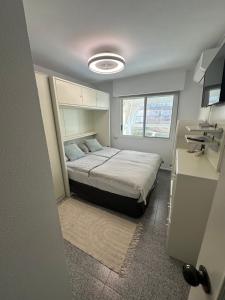 a small bedroom with a bed and a window at Apartamento Dulce & Saladar Calpe in Calpe +50 photos
