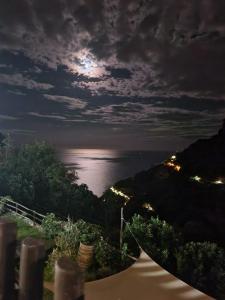 a full moon over the ocean at night at Agriturismo Orrido di Pino in Agerola