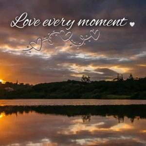 a sunset over a body of water with the words love every moment at Golf Beach and Sea in Southbroom