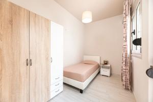 a small bedroom with a bed and a closet at HyperCenter Diamond in Kos Town