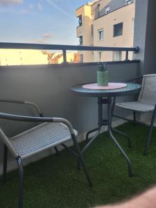 a small table and two chairs on a balcony at Apartman NS PRIVATE PARKING in Novi Sad