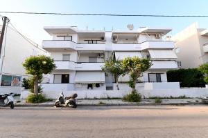 two motorcycles parked in front of a building at Sindy's House in Kos Town