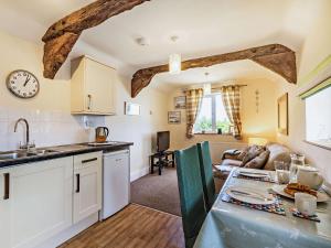 a kitchen and living room with a table and a counter at 1 Bed in Combe Martin PARSC in Berrynarbor
