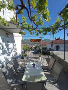 a table and chairs on a patio with a view at Apartman Maja in Trebinje