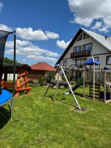 a group of playground equipment in front of a house at Camere de închiriat AnneMaryy in Arbore