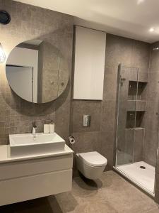 a bathroom with a sink toilet and a mirror at River View Old Town in Gdańsk