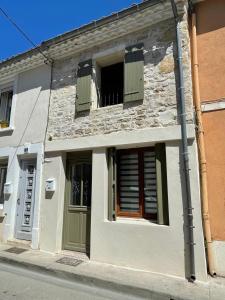 a building with an open window and a door at Whalecome Camargue in Aigues-Mortes