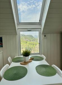 a dining room with a table and a window at Fjord road in Hjelmeland