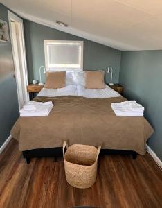 a bedroom with a large bed and a window at Nonholl country cottage - Perfect getaway in Arnarstapi
