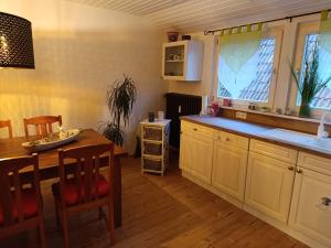 a kitchen with a table and a dining room at Ferienwohnung an den Itzauen in Großheirath