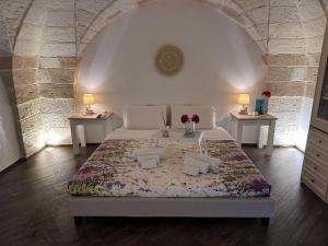 a bedroom with a bed with two tables and two lamps at Al centro exclusive apartment in Brindisi