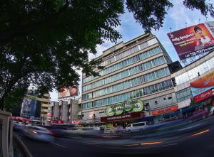 a busy city street with a building and cars at Rajah Park Hotel in Cebu City