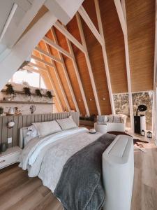 a bedroom with a large bed and a large window at Chalé Aframe- Benta Rosa Chalés de Luxo in Urubici