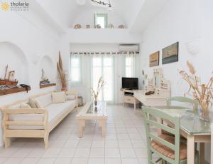 a living room with a couch and a table at Tholaria Boutique Hotel in Astypalaia Town