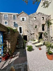 a brick building with a stone wall and stairs at Milena in Petrovac na Moru +24 photos