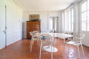 a dining room with a table and chairs at La Prévôté de Grainville - Manoir normand du XVIIIe siècle in Grainville