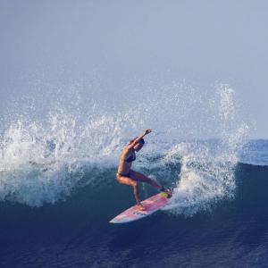 un hombre montando una ola en una tabla de surf en el océano en Hotel el Paredon, en El Paredón Buena Vista