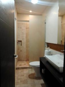 a bathroom with a toilet and a sink at Hotel BLVD in Playa del Carmen +32 photos