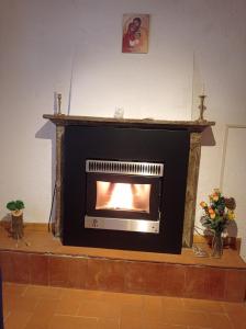 a fireplace in a living room with a fire in it at Casa vacanze Casa di Corte in Adrara San Rocco +1 photo