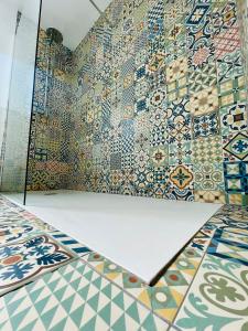a room with colorful tiles on the wall at Villa Paradise, urban oasis by -Toprentalsbarcelona- in Esplugues de Llobregat