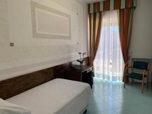 Postel nebo postele na pokoji v ubytování Hotel Conte