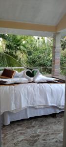 a bedroom with a bed with white sheets and a window at Dreaminn family homestay in Meenangadi