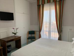 Postel nebo postele na pokoji v ubytování Hotel Conte