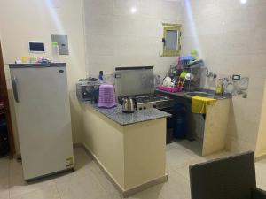 a kitchen with a sink and a stove and a refrigerator at شقه مصيف للايجار بكمبوند عجيبه سيتي مرسي مطروح in Zâwyet Umm el Rakham