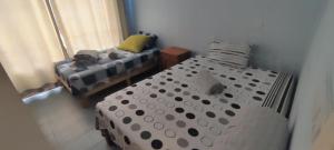 a room with a bed in a room with a bed sqor at Ashiana OceanSide Apartment in Flic-en-Flac