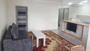 a living room with a couch and a fireplace at Cozy guest house in Sevan