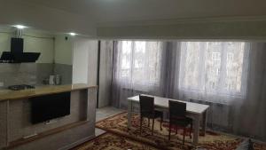 a kitchen with a table and two chairs in a room at Cozy guest house in Sevan