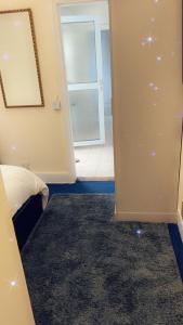 a room with a bed and a door with a window at Stay with Chris in Woking