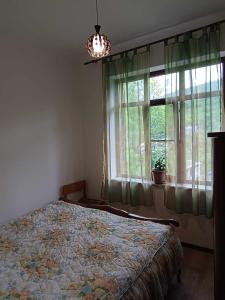 a bedroom with a bed in front of a window at Mountain View Guesthouse in Dilijan