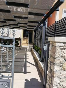 a pergola on the side of a house at Apartments Annie in Rogoznica